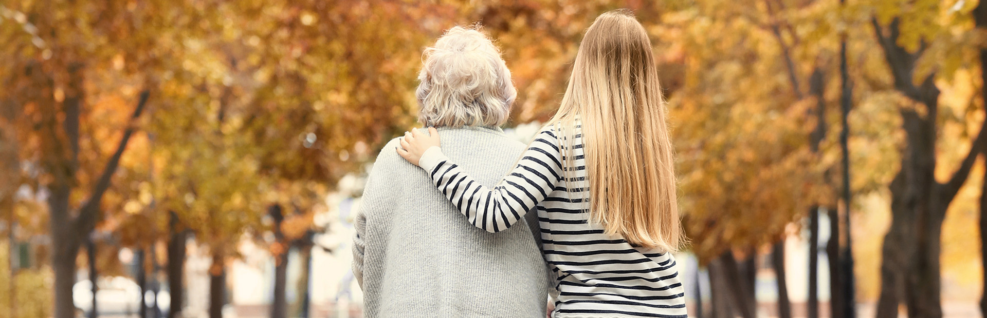 Young woman and her elderly grandmother with walking frame in au