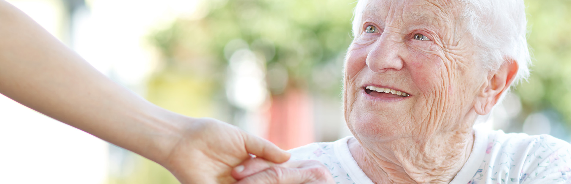 Senior woman holding hands with caretaker